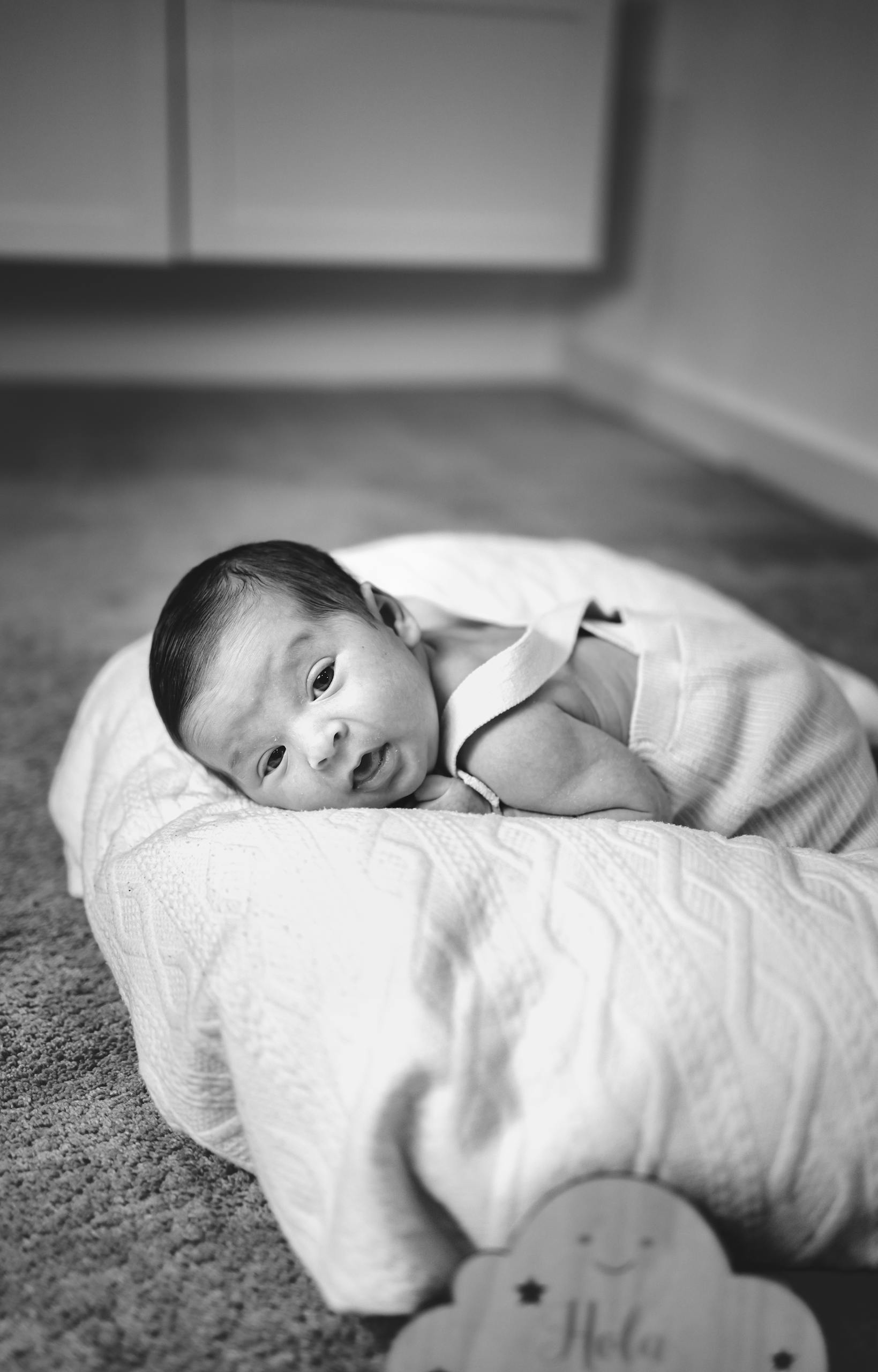 Adorable newborn baby resting on a pillow in a calm and serene setting.